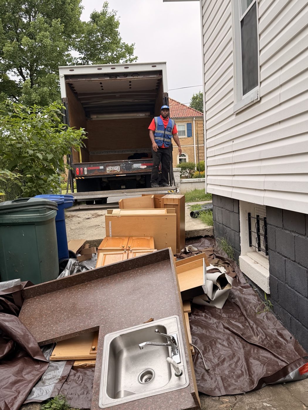 Kitchen cabinets and a sink pulled for a tear-out