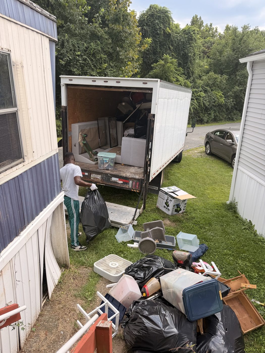 Cleanout beside a house with the truck in the yard