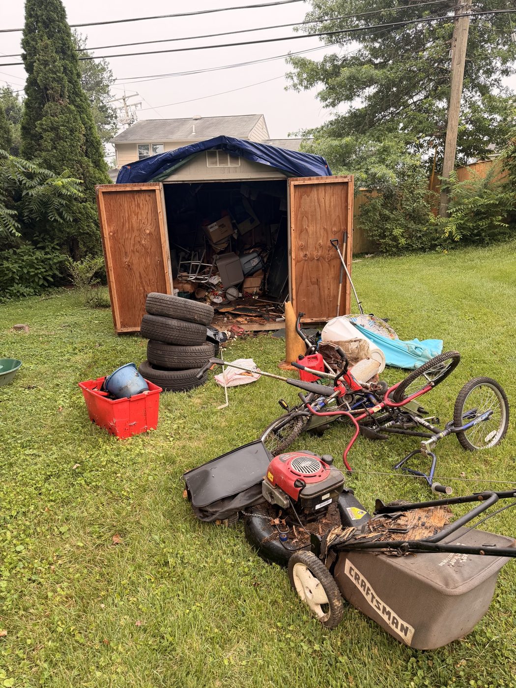 Shed cleanout with mowers, tires, and bikes